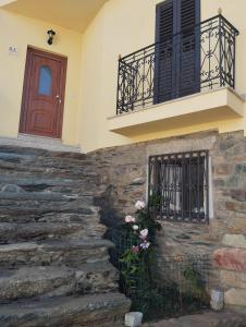 a house with a stone staircase and a balcony at Casa Ramos in Mogadouro +8 photos