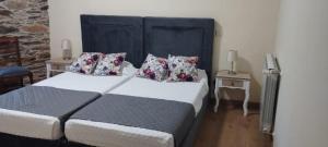 a bedroom with a large bed and two night stands at Casa Ramos in Mogadouro
