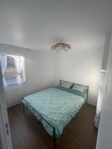 a bedroom with a bed in a room with a window at Gîte de la Nolière in La Lande-Saint-Siméon