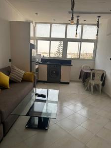 a living room with a couch and a table at Stodio sofia in Essaouira