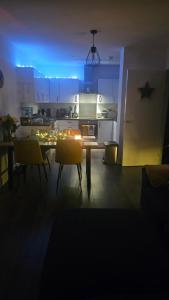 a kitchen with a table and chairs in a room at Lovely room in Chelsea in London