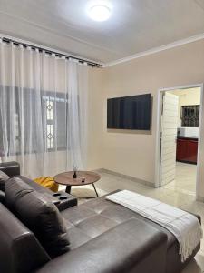 a living room with a leather couch and a table at Ekhaya Loft in Mbabane
