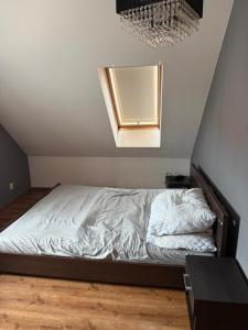 a bedroom with a bed with a mirror on the wall at Apartament Piętrowy 138m2 in Gniezno