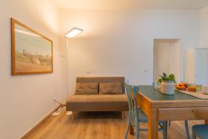 a living room with a table and a chair and a dining room at PianoPiano Nel cuore del borgo di Viterbo P1 in Viterbo +15 photos