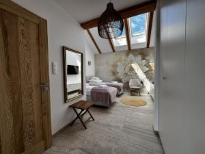 a bedroom with a bed and a mirror on the wall at Rancho Lawendowe in Szczytna