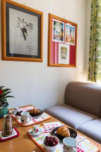 a table with food on top of it with a couch at Casa DiMì - 2 BR, 2 en-suite bath, 2 min M5, Smart lock in Milan