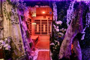 a room with a bunch of flowers on the wall at Sofia Private Wellness Apartman Prague - Sauna & Jacuzzi in Prague