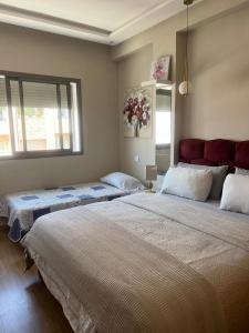 a bedroom with two beds and a window at infinity by Ghita in Rabat
