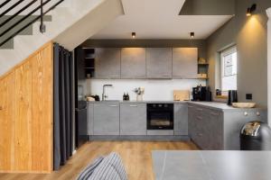 a kitchen with stainless steel cabinets and a table at Traumnest Eifel mit Sauna & Whirlpool in Monschau
