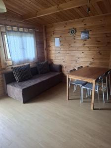 a living room with a couch and a table at Domki na Wyspie Anna in Gdańsk +12 photos