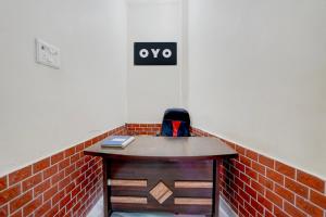 an office with a desk and a sign on the wall at SPOT ON Hotel MS Grand in Lucknow