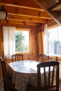 a dining room with a table and chairs and a window at Illihue - Cabañas, Hostería & Spa in Junín de los Andes +73 photos