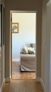 a bedroom with a bed and a door to a room at The Old Garage in Rural Northumberland in Edlingham +24 photos