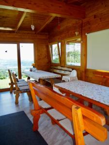 a dining room with tables and chairs and windows at Ferienwohnung Dürnberger in Liebenfels +39 photos
