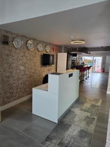 a living room with clocks on the wall at Old Ridgeway Hotel in Chingford