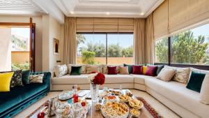 a living room with a couch and a table at Villa Amroth in Marrakesh