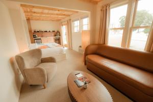 a living room with a couch and a bed at The Mill House in Bayfield
