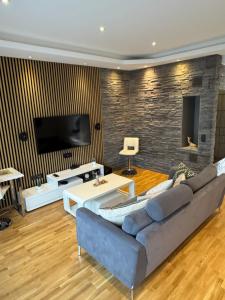 a living room with a couch and a tv at Maramaa Backyard Bliss in Viljandi