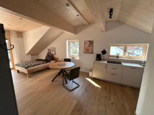 a living room with a bed and a table at Ferienhaus im Günztal in Lauben