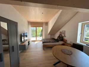 a living room with a couch and a table at Ferienhaus im Günztal in Lauben