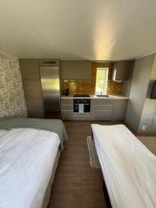 eine Küche mit zwei Betten in einem Zimmer in der Unterkunft Lantligt läge nära golfbana in Västerås