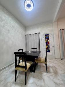 a dining room with a black table and two chairs at Casa Chu in Acapulco
