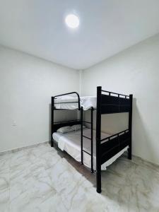 a bedroom with two bunk beds in a room at Casa Chu in Acapulco