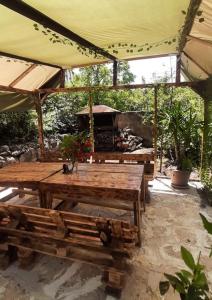 a patio with a picnic table and a grill at Relax garden area with BBQ zone in Yerevan