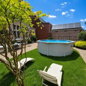 a soak in a hot tub in a yard at Spacious manor house with pool & playground in Essen