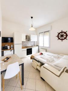 a living room with a large bed and a table at Appartamento Sole in Tessera