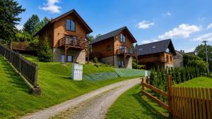 a house on a hill with a dirt road at Domki na Szlaku in Brenna
