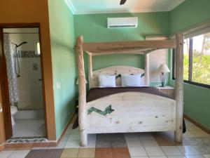 a bedroom with a wooden bed and a shower at Loreto Playa Boutique Hotel in Loreto +62 photos