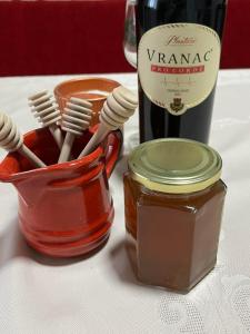 a jar of toothbrushes and a bottle of wine at Old lake house in Nikšić +18 photos
