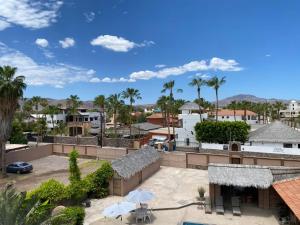 a view of the courtyard of a resort with palm trees at Loreto Playa Boutique Hotel in Loreto