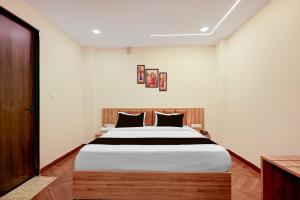 a bedroom with a large bed in a room at Hotel O Grand Shivay in Indore +30 photos