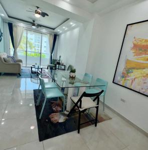 a living room with a glass table and chairs at Tepuy Residential in Juan Dolio