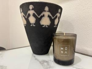 a candle sitting next to a vase with a candle at MUSA DOMO Fàinas in Càbras