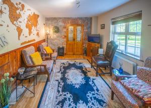 a living room with a couch and chairs at Knockaderry House in Ennis