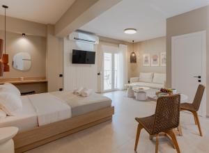 a bedroom with a large bed and a living room at Anema Living in Parga