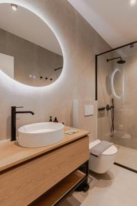 a bathroom with a tub and a toilet and a sink at Anema Living in Parga +57 photos