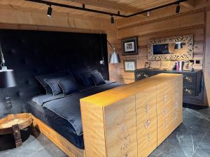 a bedroom with a large bed with a wooden headboard at Tatra Whisper Chalet in Ząb