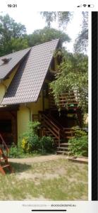a house with a porch and stairs in front of it at Mariolka Skorzęcin in Skorzęcin