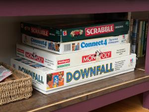 a stack of video game boxes on a shelf at The Old Tearooms in Rural Northumberland in Edlingham