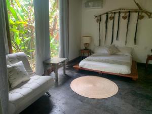 a living room with a bed and a couch at Villas Boutique Antheia in La Orilla