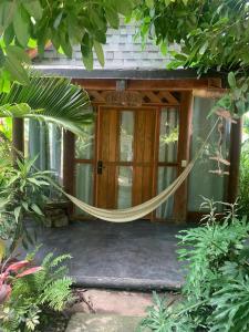 a hammock in front of a house at Villas Boutique Antheia in La Orilla