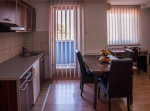 a kitchen with a table and chairs and a dining room at Modex Apartments in Paraćin