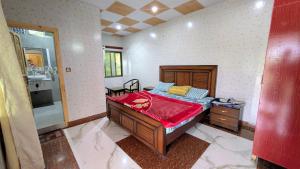 a bedroom with a bed and a sink in it at Afridi Apartment in Murree