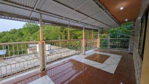 an empty balcony with a view of trees at Afridi Apartment in Murree