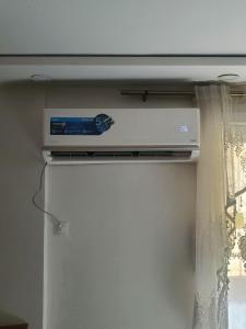 a dvd player sitting on top of a refrigerator at Appartement a bir mourad rais in Birmandreis