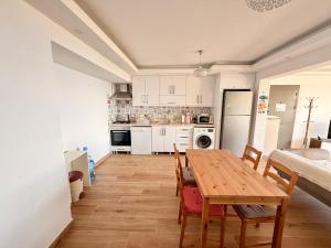 a kitchen and dining room with a table and chairs at BODRUM BURCU RESIDENCE, Magnificent Sea View, Cozy, Free Otopark, Free Wifi in Bodrum City